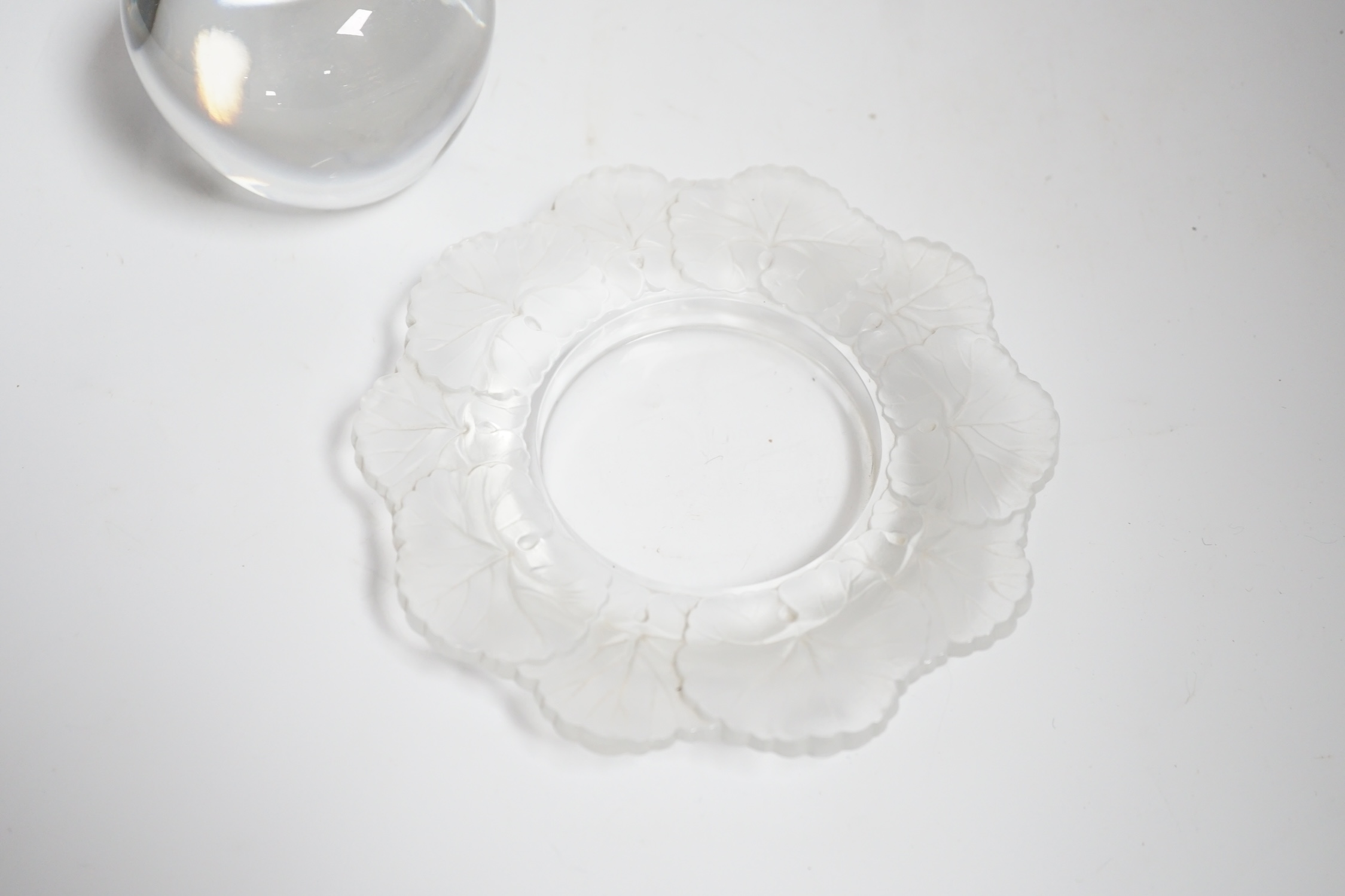 A small Lalique 'Honfleur' dish with frosted leaf border, diameter 15cm and a Tiffany glass 'Apple' paperweight